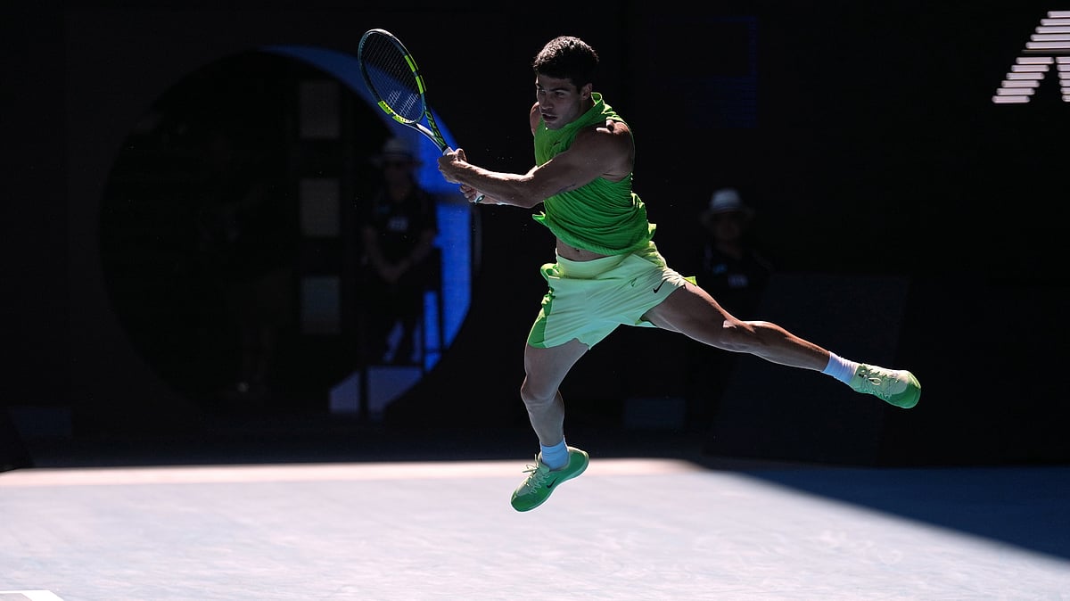 Carlos Alcaraz of Spain plays a backhand return to Alexander Zverev of Germany during their semifinal match at the Australian Open tennis championship in Melbourne, Australia, Friday, Jan. 30, 2026.  - (AP Photo/Dita Alangkara)