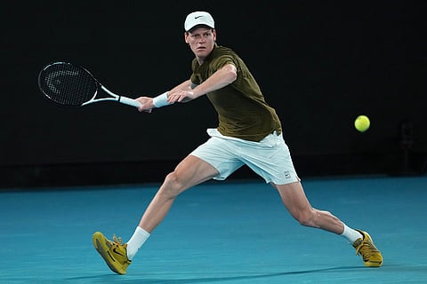 Jannik Sinner of Italy plays a forehand return to Novak Djokovic of Serbia during their semifinal match at the Australian Open tennis championship in Melbourne, Australia.