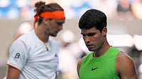 AP : Carlos Alcaraz, right, of Spain walks past Alexander Zverev of Germany during their semifinal match