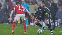 | Photo: AP/Armando Franca : Real Madrid's Kylian Mbappe, right, vies for the ball with Benfica's Andreas Schjelderup during a Champions League opening phase soccer match between Benfica and Real Madrid, in Lisbon, Wednesday, Jan. 28, 2026.