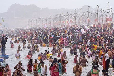 People take a holy dip at Sangam during the ongoing Magh Mela 2026, in Prayagraj, Uttar Pradesh.