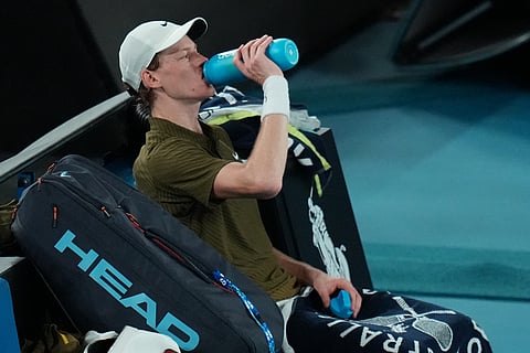 Jannik Sinner of Italy takes a drink during his semifinal match against Novak Djokovic of Serbia at the Australian Open tennis championship in Melbourne, Australia.