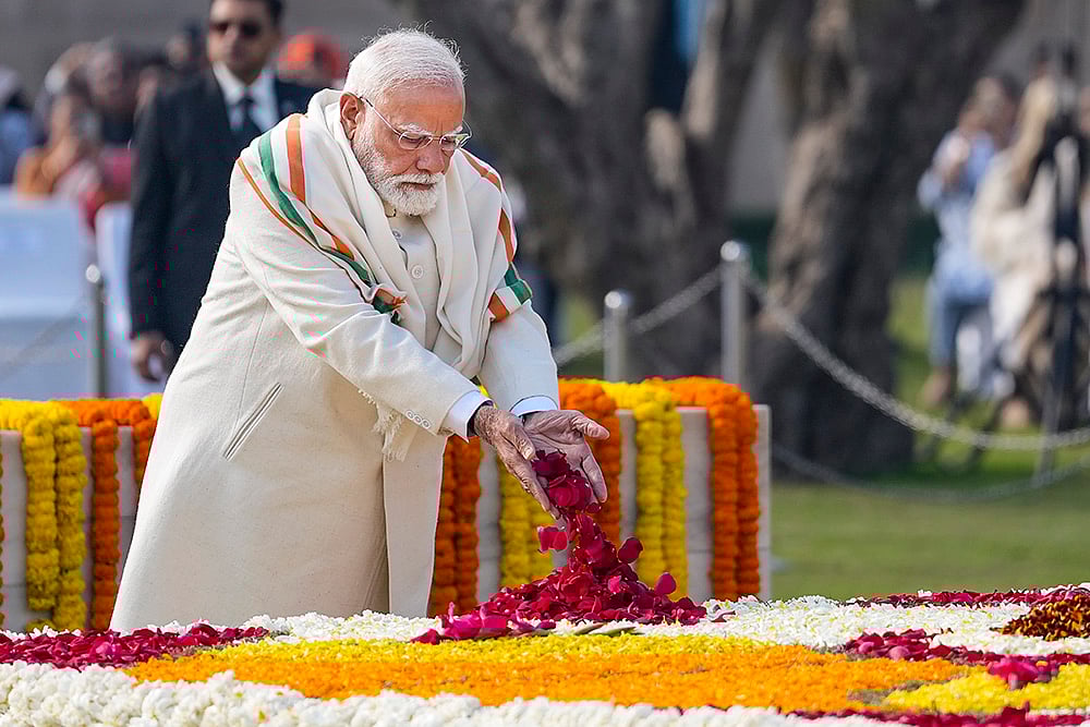 Prime Minister Narendra Modi pays tribute to Mahatma Gandhi at Rajghat on the occasion of Martyrs' Day, observed to mark the death anniversary of the father of the nation, in New Delhi. - | Photo: PTI/Ravi Choudhary