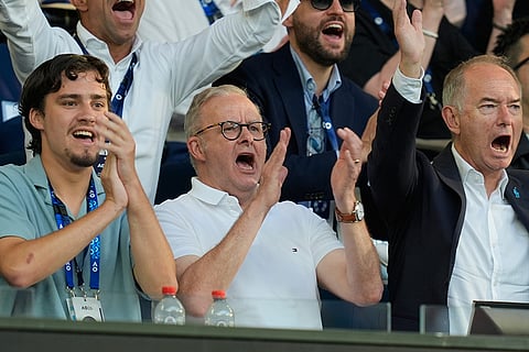 Australian Prime Minister Anthony Albanese, center, reacts as he watches the Carlos Alcaraz of Spain and Alexander Zverev of Germany semifinal match at the Australian Open tennis championship in Melbourne, Australia.