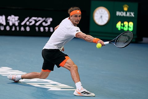 Alexander Zverev of Germany plays a backhand return to Carlos Alcaraz of Spain during their semifinal match at the Australian Open tennis championship in Melbourne, Australia.