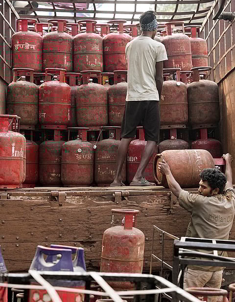 Workers load cylinders on a vehicle, ahead of the presentation of the Union Budget 2026-27 by Union Finance Minister Nirmala Sitharaman, in Kolkata.