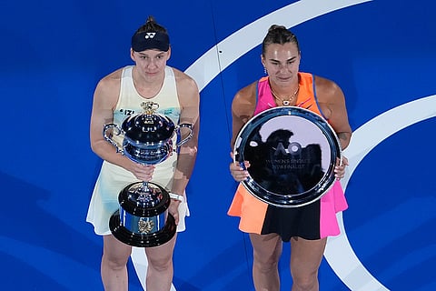 Elena Rybakina of Kazakhstan holds The Daphne Akhurst Memorial Cup, left after defeating Aryna Sabalenka of Belarus at right during the trophy ceremony for the women's singles final at the Australian Open tennis championship in Melbourne, Australia.