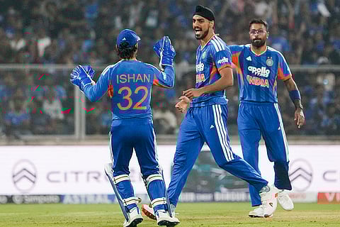 India's Arshdeep Singh, centre, celebrates with Hardik Pandya, right, and Ishan Kishan after taking the wicket of New Zealand's captain Mitchell Santner during the fifth and final T201 cricket match between India and New Zealand, at the Greenfield International Stadium, in Thiruvananthapuram, Kerala.
