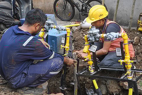 Workers install a gas pipeline, ahead of the presentation of the Union Budget 2026-27 by Union Finance Minister Nirmala Sitharaman, in Mumbai.
