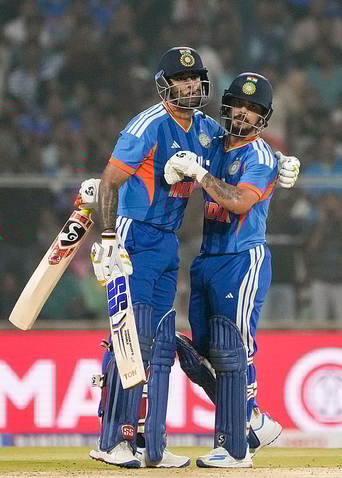 India's Ishan Kishan, right, celebrates his half century with captain Suryakumar Yadav during the fifth and final T20 International cricket match between India and New Zealand, at the Greenfield International Stadium, in Thiruvananthapuram.