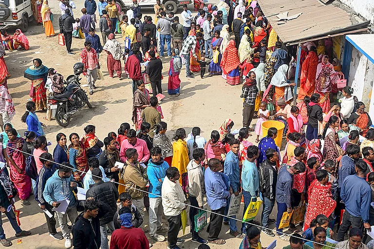 People wait in queues outside a camp during hearings under the Special Intensive Revision (SIR) of electoral rolls, in Malda, West Bengal. - | Photo: PTI