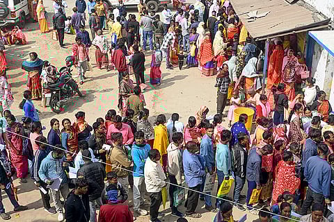 People wait in queues outside a camp during hearings under the Special Intensive Revision (SIR) of electoral rolls, in Malda, West Bengal.