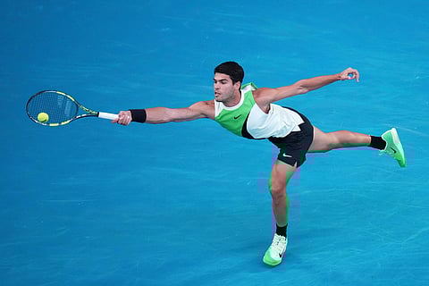 Carlos Alcaraz of Spain plays a forehand return to Novak Djokovic of Serbia in their final match at the Australian Open tennis championship in Melbourne, Australia.