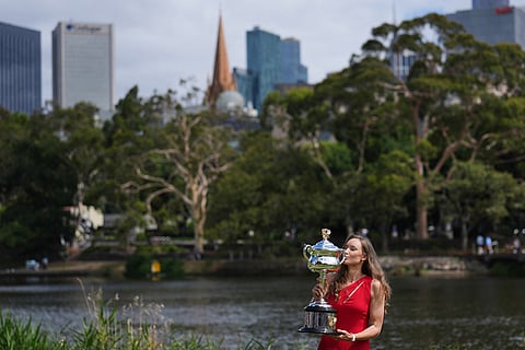 Elena Rybakina of Kazakhstan poses with Daphne Akhurst Memorial Cup on the banks of the Yarra River the morning after defeating Aryna Sabalenka of Belarus in the women's singles final at the Australian Open tennis championship in Melbourne, Australia.