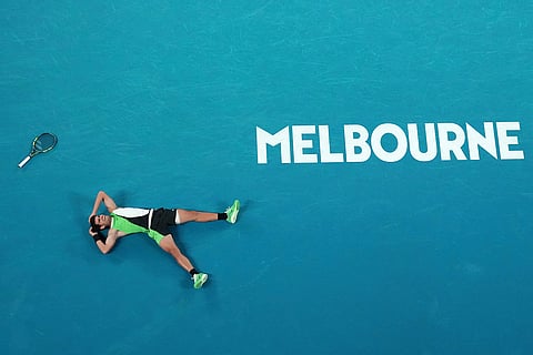 Carlos Alcaraz of Spain reacts after winning the men's singles final match against Novak Djokovic of Serbia at the Australian Open tennis championship in Melbourne, Australia.