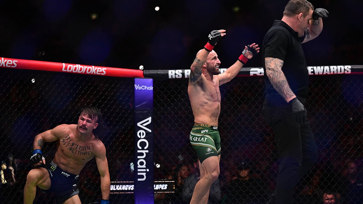 Alex Volkanovski, center, of Australia, in his featherweight title bout fights against Diego Lopes, of Brazil - AAP