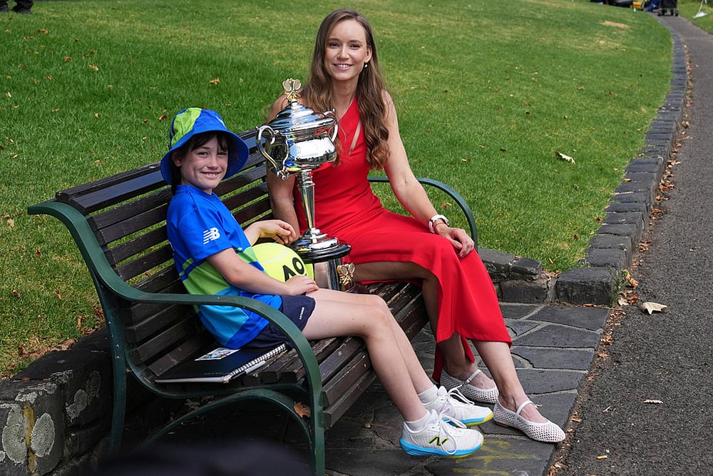 Elena Rybakina of Kazakhstan sits with ballkid Gladys Jarry