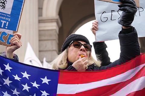 A person blows a whistle, during an Anti-ICE demonstration, ahead of the 2026 Winter Olympics, in Milan, Italy.