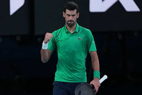 Novak Djokovic of Serbia celebrates winning the first set against Carlos Alcaraz of Spain during the men's singles final at the Australian Open tennis championship in Melbourne, Australia.