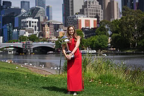 Elena Rybakina of Kazakhstan poses with Daphne Akhurst Memorial Cup on the banks of the Yarra River the morning after defeating Aryna Sabalenka of Belarus in the women's singles final at the Australian Open tennis championship in Melbourne, Australia.