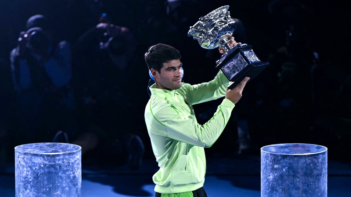 Carlos Alcaraz holds the Norman Brookes Challenge Cup aloft. - null