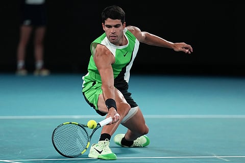 Carlos Alcaraz of Spain plays a forehand return to Novak Djokovic of Serbia during the men's singles final at the Australian Open tennis championship in Melbourne, Australia.
