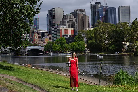 Elena Rybakina of Kazakhstan poses with Daphne Akhurst Memorial Cup on the banks of the Yarra River the morning after defeating Aryna Sabalenka of Belarus in the women's singles final at the Australian Open tennis championship in Melbourne, Australia.
