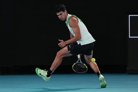 Carlos Alcaraz of Spain plays a back between his legs to Novak Djokovic of Serbia during the men's singles final at the Australian Open tennis championship in Melbourne, Australia.