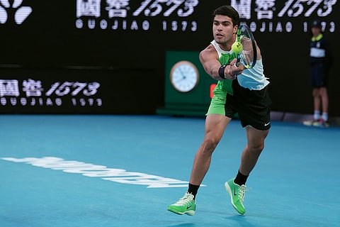 Carlos Alcaraz of Spain plays a backhand return to Novak Djokovic of Serbia during the men's singles final at the Australian Open tennis championship in Melbourne, Australia.