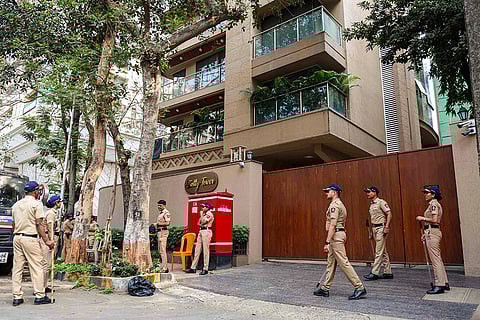 Police personnel stand guard outside filmmaker Rohit Shetty's house after unidentified persons opened fire at his multi-storey residence, at Juhu area, in Mumbai, Maharashtra.