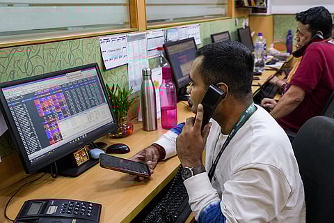 Traders react after fluctuations in stock market, in Kolkata. Stock market benchmark indices Sensex and Nifty tumbled on Sunday afternoon trade after the Budget proposed to raise Securities Transaction Tax to 0.05 per cent on commodity futures from 0.02 per cent.