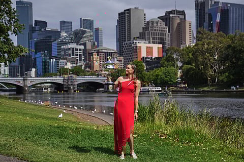 Elena Rybakina of Kazakhstan poses with Daphne Akhurst Memorial Cup on the banks of the Yarra River the morning after defeating Aryna Sabalenka of Belarus in the women's singles final at the Australian Open tennis championship in Melbourne, Australia.