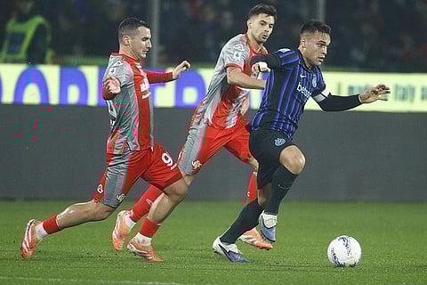 Inter's Lautaro Martinez, right, controls the ball during the Serie A soccer match between Cremonese and Inter in Cremona, Italy.