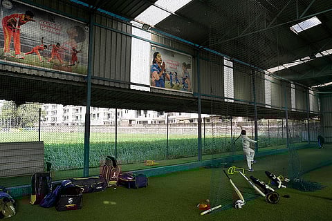 A young girl bowling inside the nets at Nagesh Gupta's academy in Zirakhpur. 