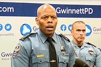 (WSB via AP) : An image taken from WSB video shows Gwinnett County Police Chief J.D. McClure speaks at a news conference Sunday, Feb. 1, 2026, in Gwinnett County, Ga., following the shootings of two officers at a hotel. 