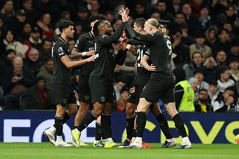 Manchester City's Antoine Semenyo, center, is congratulated after scoring his side's 2nd goal during the English Premier League soccer match between Tottenham Hotspur and Manchester City in London.