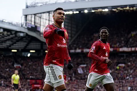 Manchester United's Casemiro celebrates after scoring the opening goal during the English Premier League soccer match between Manchester United and Fulham in Manchester, England.
