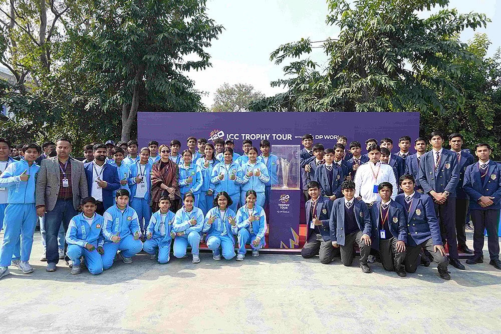 Students of Delhi Public School, Aligarh pose with the ICC Men’s T20 World Cup 2026 trophy during its visit - null