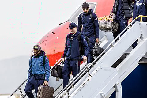 New England Patriots quarterback Drake Maye, center, disembarks the team plane upon arrival at Mineta International Airport in San Jose, California ahead of NFL football's Super Bowl LX. 
