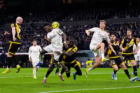 Real Madrid's Vinicius Junior, center left, heads for the ball during the Spanish La Liga soccer match between Real Madrid and Rayo Vallecano in Madrid, Spain.