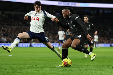 Manchester City's Antoine Semenyo, right, and Tottenham's Archie Gray compete for the ball during the English Premier League soccer match between Tottenham Hotspur and Manchester City in London.
