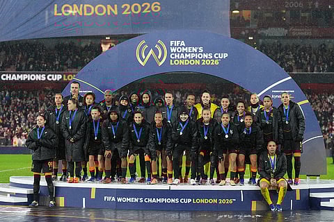 Corinthians players pose after receiving their second place medals at the the end of the Women's Champions Cup final soccer match between Arsenal FC and SC Corinthians in London.