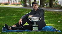 What Next For Carlos Alcaraz? Calendar Slam Talks Grow After Spaniard's Historic Australian Open Win | Photo: AP/Dita Alangkara : Carlos Alcaraz of Spain poses with the Norman Brookes Challenge Cup the morning after defeating Novak Djokovic of Serbia in the men's singles final at the Australian Open tennis championship, in Melbourne, Australia, Monday, Feb. 2, 2026.