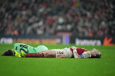 Arsenal's Lotte Wubben-Moy, right, and Arsenal's goalkeeper Anneke Borbe lie on the pitch after colliding during the Women's Champions Cup final soccer match between Arsenal FC and SC Corinthians in London.