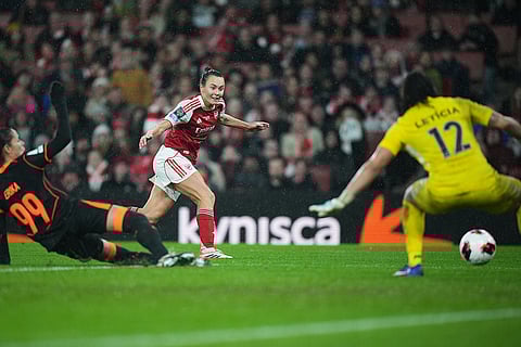 Arsenal's Caitlin Foord, center, scores her side's third goal during the Women's Champions Cup final soccer match between Arsenal FC and SC Corinthians in London.