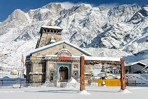 The 'Kedarnath Dham' is seen against snow-capped mountains after fresh snowfall, in Rudraprayag, Uttarakhand.