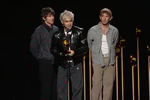 Brendan Yates, from left, Daniel Fang, and Pat McCrory of Turnstile accept the award for best metal performance for "Birds" during the 68th annual Grammy Awards in Los Angeles. 