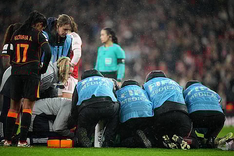 Arsenal's goalkeeper Anneke Borbe gets medical assistance after a collision with teammate Lotte Wubben-Moy during the Women's Champions Cup final soccer match between Arsenal FC and SC Corinthians in London.