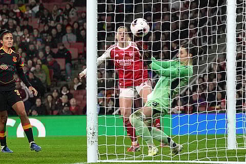 Arsenal's Alessia Russo, center, watches as Arsenal's goalkeeper Anneke Borbe fails to stop the ball going over the line to allow Corinthian's first goal, by team captain Gabi Zanotti, during the Women's Champions Cup final soccer match between Arsenal FC and SC Corinthians in London.