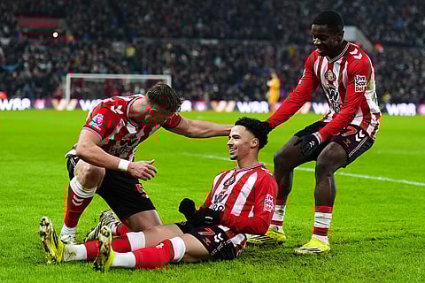 Sunderland's Chemsdine Talbi, center, celebrates with teammates after scoring their side's third goal of the game during the Premier League soccer match against Burnley, at the Stadium of Light, in Sunderland, England.